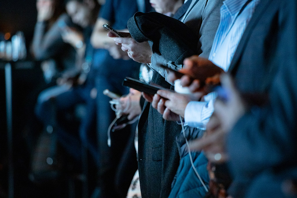 Group of people using their phone simultaneously